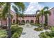 Charming courtyard with fountain surrounded by tropical palms and architecture at 5440 Manatee Point Drive, New Port Richey, FL 34652