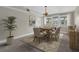 Dining area featuring a wooden table with seating for six, neutral colors, and views of the canal at 5440 Manatee Point Drive, New Port Richey, FL 34652