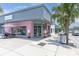 Exterior view of a pink ice cream shop with playful decor and sidewalk seating at 5440 Manatee Point Drive, New Port Richey, FL 34652