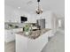 Spacious kitchen features white cabinets, stainless steel appliances, a large island, and views into the living area at 5440 Manatee Point Drive, New Port Richey, FL 34652