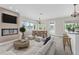Inviting living room with an electric fireplace, comfortable seating, dining area and breakfast bar at 5440 Manatee Point Drive, New Port Richey, FL 34652