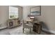Well-appointed home office featuring a desk, shelving, patterned rug, and a bright window at 5440 Manatee Point Drive, New Port Richey, FL 34652