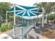 Playground area with a large sun shade and many slides and interactive areas at 5440 Manatee Point Drive, New Port Richey, FL 34652