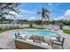 Inviting backyard pool with comfortable patio furniture and scenic waterfront views at 5440 Manatee Point Drive, New Port Richey, FL 34652