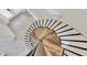 Overhead view of a spiral staircase with marble treads and black railing, leading to the next floor at 5440 Manatee Point Drive, New Port Richey, FL 34652