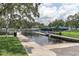 Picturesque waterfront featuring a boat ramp, pier, and scenic views of the bridge and surrounding greenery at 5440 Manatee Point Drive, New Port Richey, FL 34652
