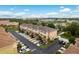 Aerial view of a neighborhood's townhomes, private parking spots, and manicured landscape at 5520 White Marlin Ct, New Port Richey, FL 34652