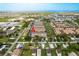 Aerial view of residential townhomes near bodies of water with blue skies and green vegetation at 5520 White Marlin Ct, New Port Richey, FL 34652