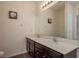 Bathroom showcasing a double sink vanity with a large mirror and modern light fixture at 5520 White Marlin Ct, New Port Richey, FL 34652