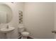 Neutral half bathroom featuring a pedestal sink, wall decor, and modern fixtures at 5520 White Marlin Ct, New Port Richey, FL 34652