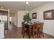 Dining room with dark wood table, wooden chairs, and view into kitchen at 5520 White Marlin Ct, New Port Richey, FL 34652