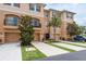 Inviting townhouse showcasing a private balcony, single-car garage, and meticulously maintained front yard landscaping at 5520 White Marlin Ct, New Port Richey, FL 34652