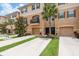 Charming townhome with a beige exterior, complemented by lush landscaping and a private, attached one-car garage at 5520 White Marlin Ct, New Port Richey, FL 34652