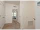 Hallway showcasing a glimpse into the bedroom, neutral colors, and plush carpeting at 5520 White Marlin Ct, New Port Richey, FL 34652