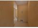 Beige painted hallway with gray flooring and a doorway leading to another room in the house at 5520 White Marlin Ct, New Port Richey, FL 34652