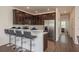 Kitchen with stainless steel appliances, dark wood cabinets, and a bar top with seating at 5520 White Marlin Ct, New Port Richey, FL 34652