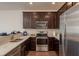 Modern kitchen featuring stainless steel appliances, dark wood cabinets, and bright white countertops at 5520 White Marlin Ct, New Port Richey, FL 34652