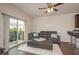 Open-concept living room with balcony access, wood floors, and comfortable seating at 5520 White Marlin Ct, New Port Richey, FL 34652