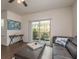 Bright living area featuring a sliding glass door to the balcony and modern decor elements for a relaxing ambiance at 5520 White Marlin Ct, New Port Richey, FL 34652