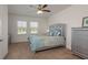 Main bedroom featuring natural light, a ceiling fan, and stylish decor at 5520 White Marlin Ct, New Port Richey, FL 34652
