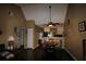 Dining room features wood floors, neutral paint, and views into the kitchen at 6338 Spring Flower Dr # 21, New Port Richey, FL 34653