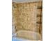 A tiled bathtub and shower with a convenient shower caddy for storage at 6462 92Nd N Pl # 806, Pinellas Park, FL 33782