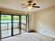 This bedroom has sliding glass doors that lead to a wood deck at 6462 92Nd N Pl # 806, Pinellas Park, FL 33782