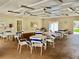 Community clubhouse featuring tables, chairs, ceiling fans, and an open patio at 6462 92Nd N Pl # 806, Pinellas Park, FL 33782