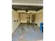 Open garage with storage and access door to laundry room at 6462 92Nd N Pl # 806, Pinellas Park, FL 33782