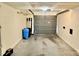 Spacious garage with gray door, concrete floor and overhead lighting at 6462 92Nd N Pl # 806, Pinellas Park, FL 33782