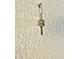 Close-up shot of a key hanging on a textured white wall at 6462 92Nd N Pl # 806, Pinellas Park, FL 33782