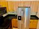 Kitchen with stainless steel refrigerator and wooden cabinets at 6462 92Nd N Pl # 806, Pinellas Park, FL 33782