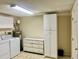 Well-equipped laundry room with washer, dryer, water heater, storage cabinet and chest of drawers for organization at 6462 92Nd N Pl # 806, Pinellas Park, FL 33782