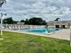 Sparkling community pool with ample lounge chairs, manicured landscaping, and serene atmosphere at 6462 92Nd N Pl # 806, Pinellas Park, FL 33782