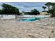 Bright community pool area featuring lounge chairs and pristine landscaping at 6462 92Nd N Pl # 806, Pinellas Park, FL 33782