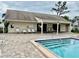 Pool area with lounge chairs near spa and pool house at 6462 92Nd N Pl # 806, Pinellas Park, FL 33782