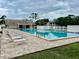 Community pool featuring pristine blue waters, lounge seating and manicured grounds at 6462 92Nd N Pl # 806, Pinellas Park, FL 33782