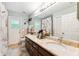 Bathroom featuring a double vanity with a granite countertop, and a shower at 6505 Broadwing Ct, Tampa, FL 33625