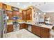Well-appointed kitchen with wood cabinetry, stainless appliances and ample counter space at 6505 Broadwing Ct, Tampa, FL 33625