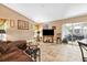 Spacious living room featuring tile flooring, comfortable seating, and sliding door access to lanai at 6505 Broadwing Ct, Tampa, FL 33625