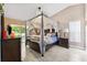 Beautiful bedroom with a canopy bed and access to the patio at 6505 Broadwing Ct, Tampa, FL 33625