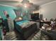 Bedroom with colorful walls, cozy bedding, and a ceiling fan at 717 Whiteway Dr, Brooksville, FL 34601