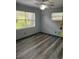 Bright bedroom with modern floors, natural light, and a ceiling fan at 717 Whiteway Dr, Brooksville, FL 34601