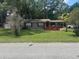 Charming single-story home with a covered carport and well-maintained front lawn at 717 Whiteway Dr, Brooksville, FL 34601