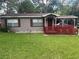 Charming single-story home with a covered carport and well-maintained front lawn at 717 Whiteway Dr, Brooksville, FL 34601