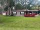 Charming single-story home with a covered carport and well-maintained front lawn at 717 Whiteway Dr, Brooksville, FL 34601