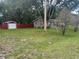 Charming single-story home and shed, surrounded by mature trees and a spacious lawn at 717 Whiteway Dr, Brooksville, FL 34601