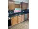 Functional kitchen featuring oak cabinets, stainless steel appliances, and tile flooring at 717 Whiteway Dr, Brooksville, FL 34601