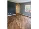 An empty living room with wood flooring and a gray color scheme at 717 Whiteway Dr, Brooksville, FL 34601