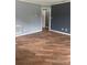 An empty living room with wood flooring and a gray color scheme at 717 Whiteway Dr, Brooksville, FL 34601